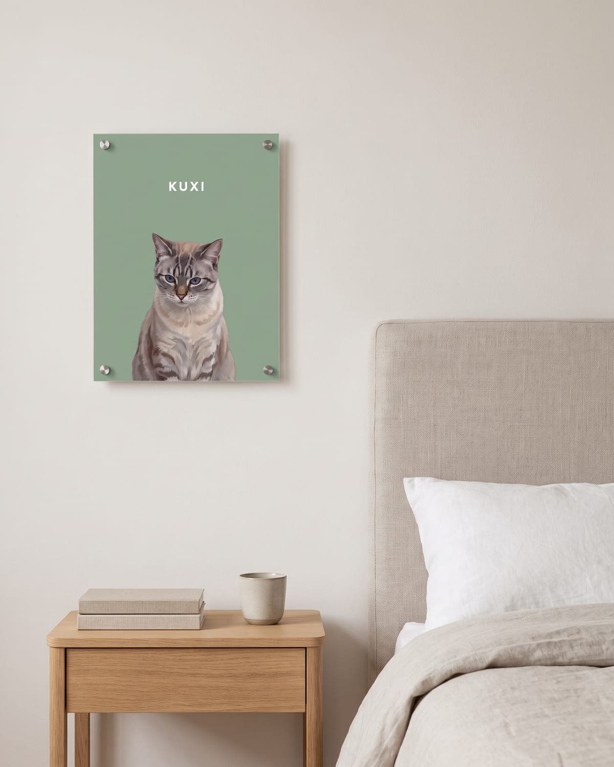 Pet Portrait of a cat on a sage green background, acrylic with metal standoffs, on the wall above a nightstand